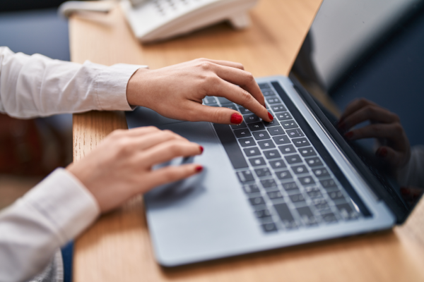 young-caucasian-woman-using-laptop-office